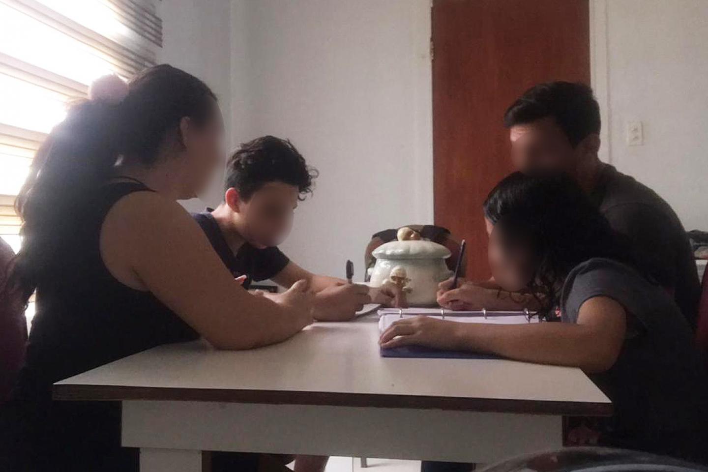 A family does homework around the table